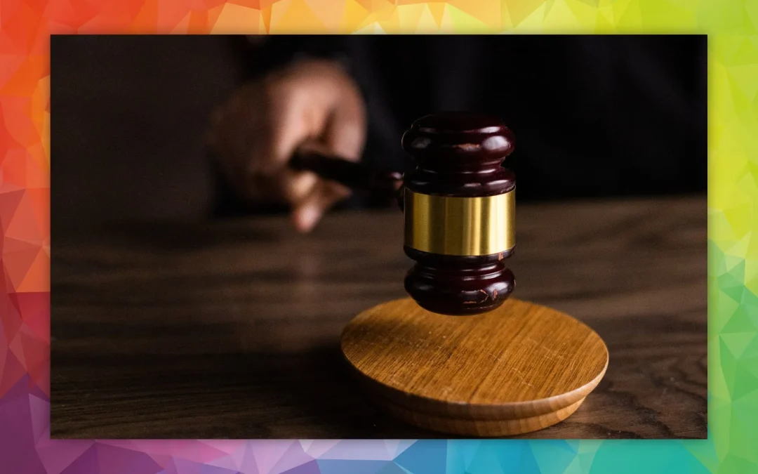 Close-up of a gavel on a table with a colorful background.